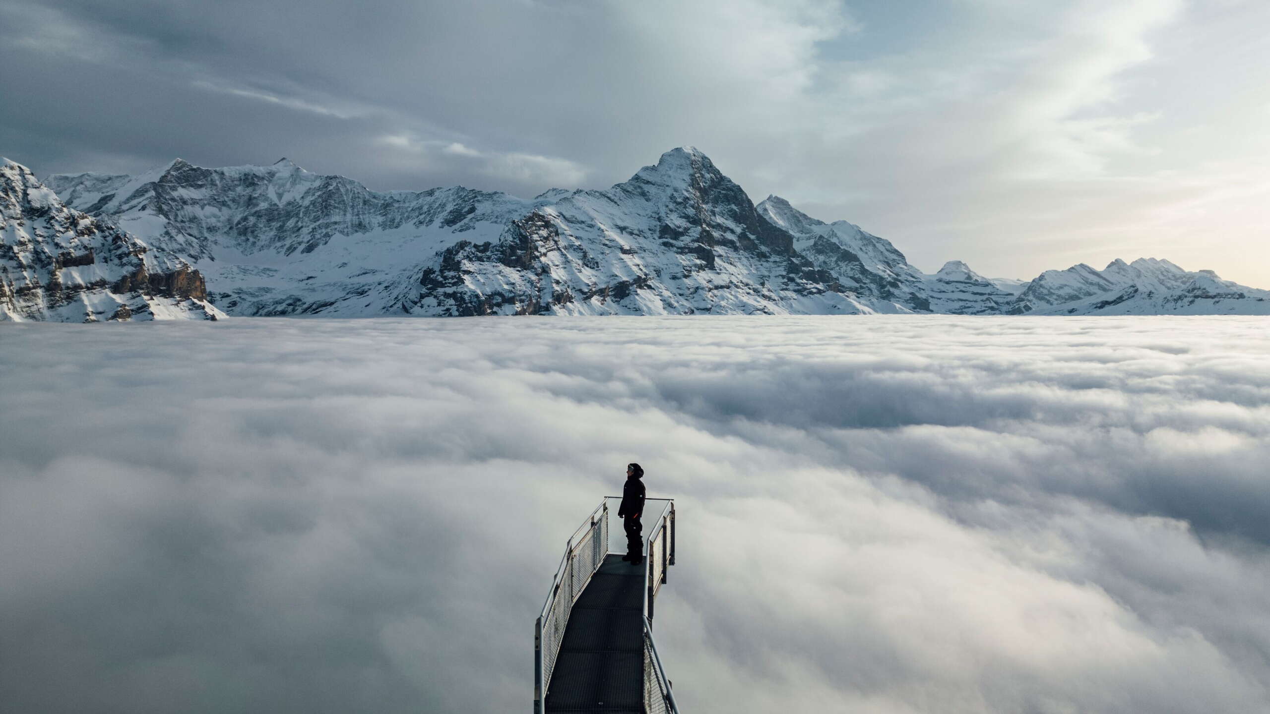 Grindelwald First, Cliff Walk in a wintry evening atmosphere with a sea of fog.