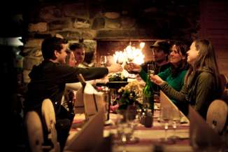 Anstossen mit Wein: Eine Gruppe beim Nachtessen im Bergrestaurant Mägisalp am Hasliberg.